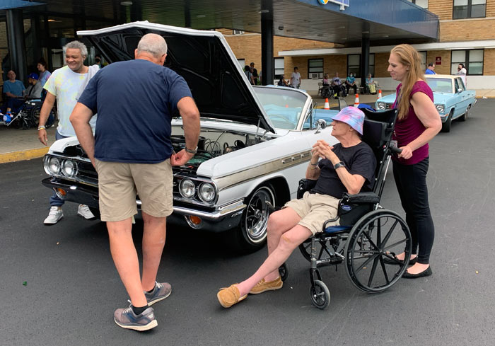 Buick Wildcat and Plymouth Valiant with residents